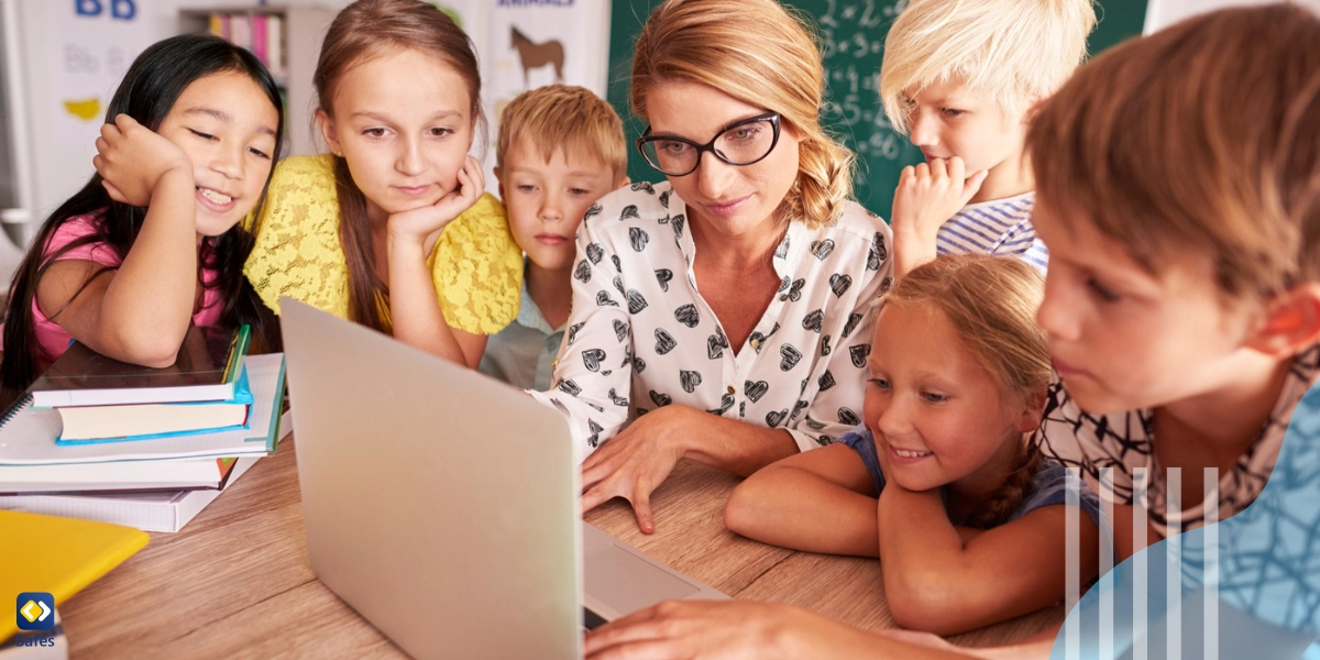 Students and teacher looking at laptop