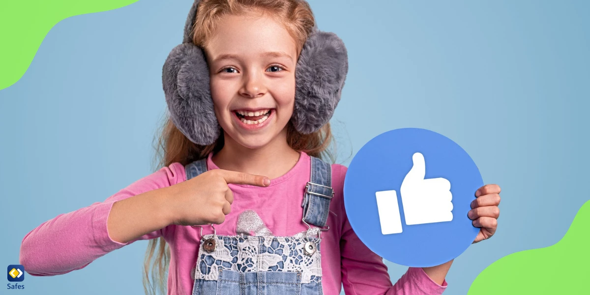 a cheerful little girl is holding a sign of thumb up