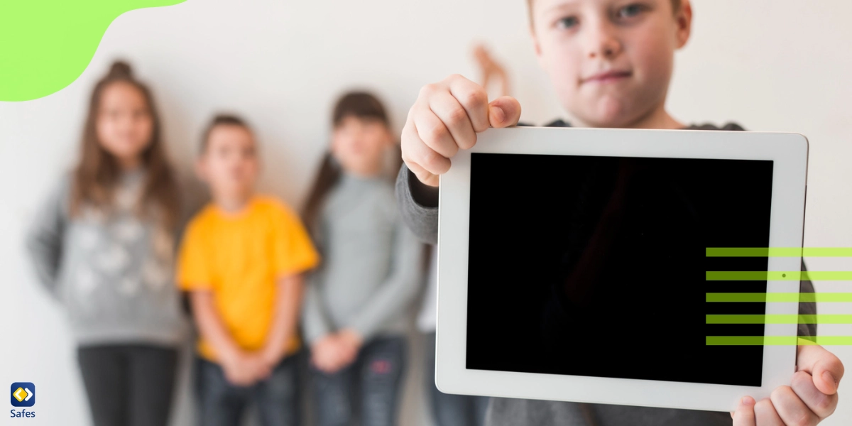 A boy is showing his tablet