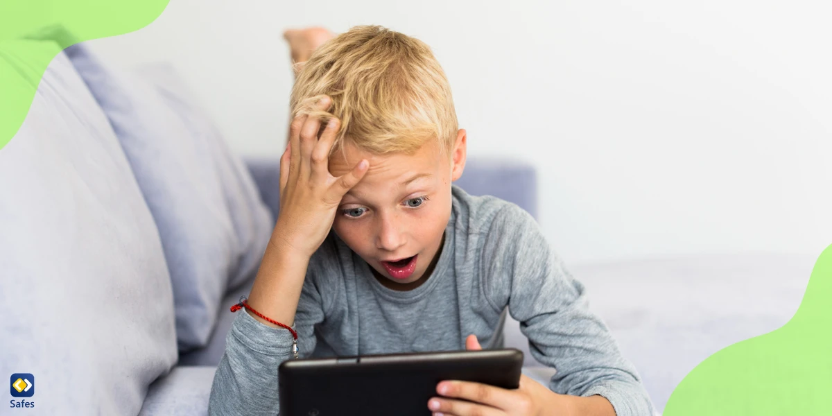 a little boy is looking at a tablet surprisingly