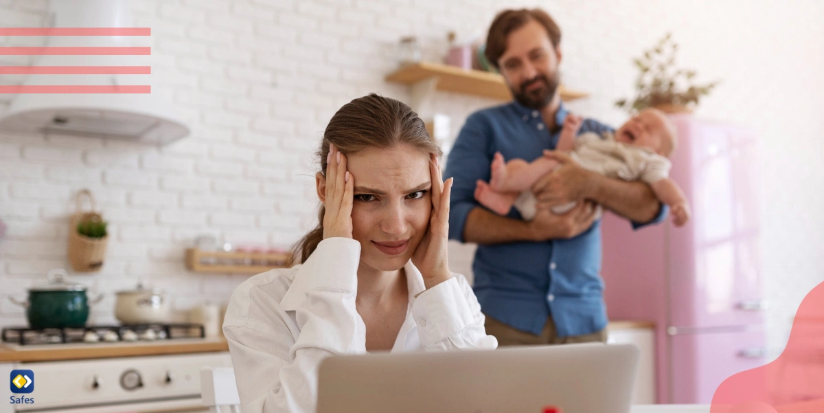 Distracted mom trying to work while dad holds infant