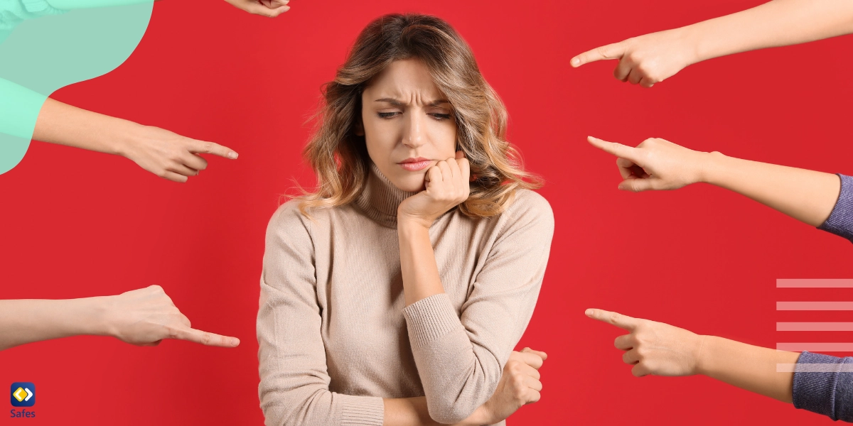 Fingers pointing at a mother as if trying to accuse her of being a bad mother and make her feel mom guilt