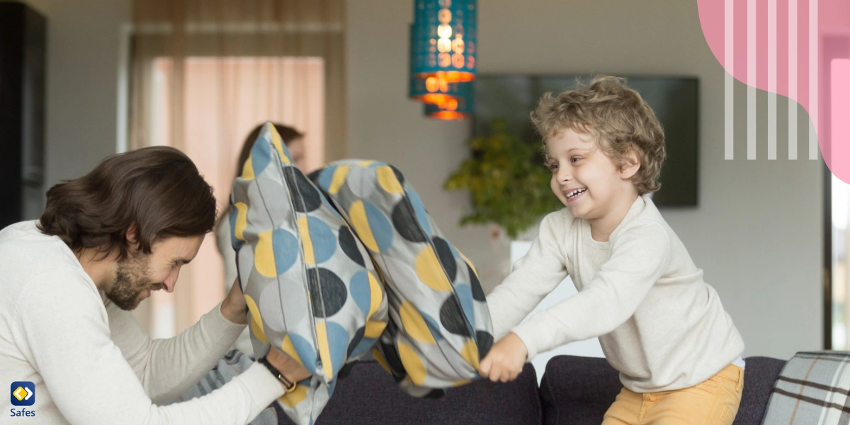 Father and little boy pillow fighting