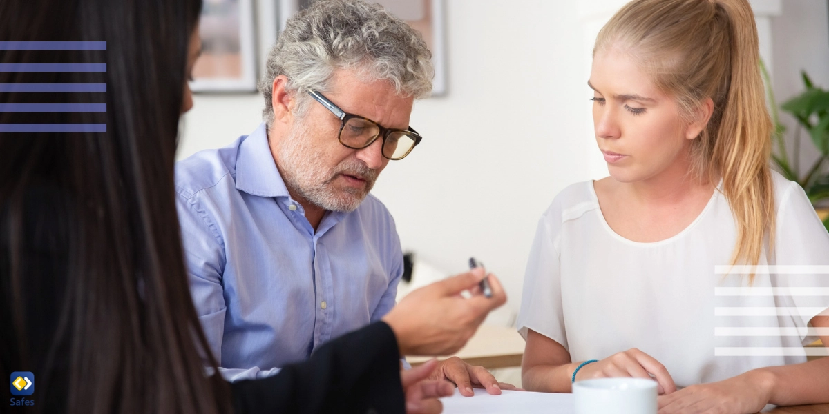Three people discussing over a document] 