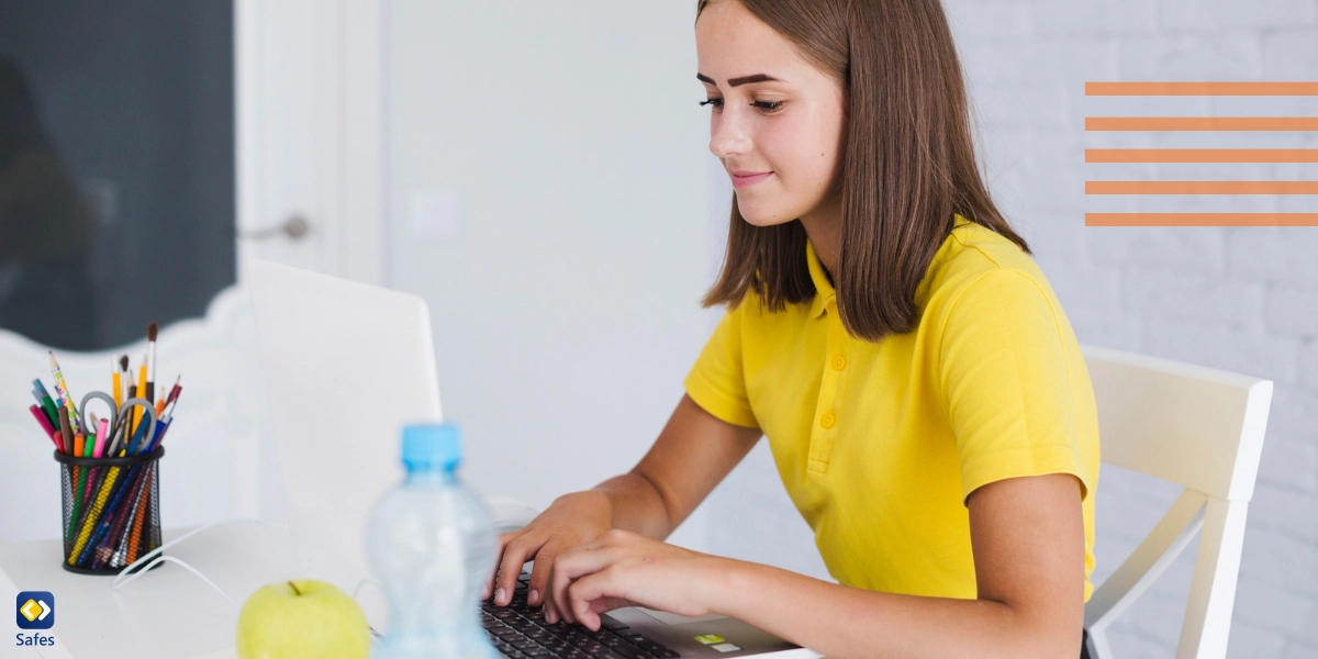 Teenage girl reading and writing stories on the Wattpad website using her laptop