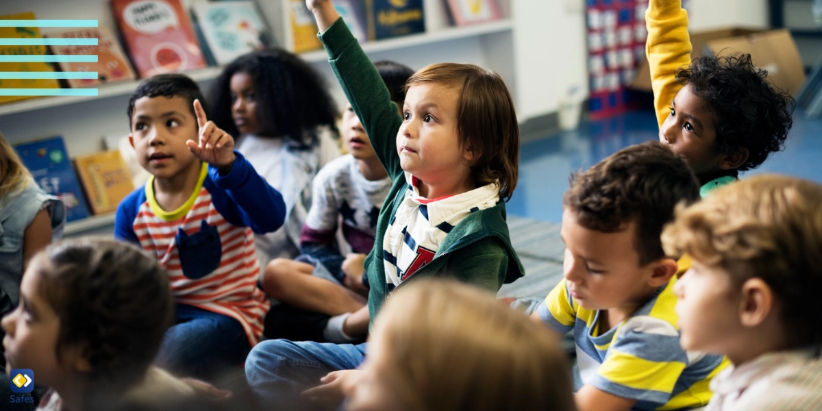 Children raising their hand politely in classroom because of successful behavioral modification plan