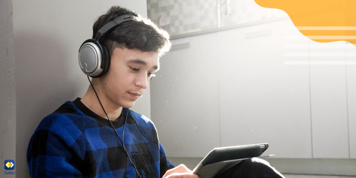 Teenage boy listening to SoundCloud on his tablets safely