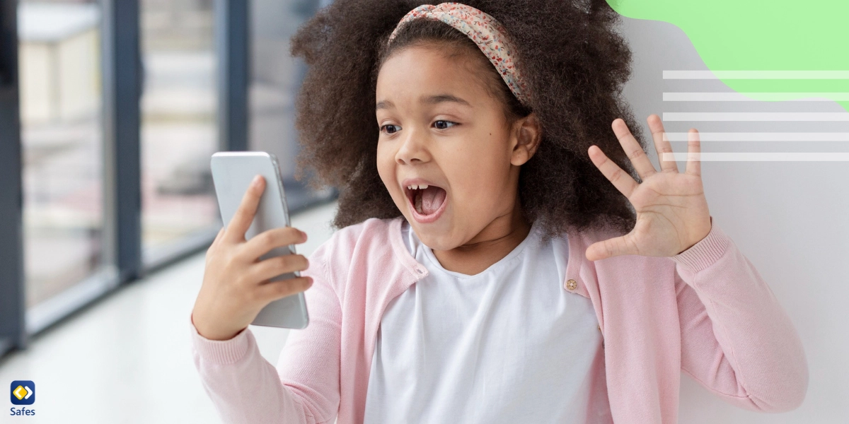 Surprised little girl looking at phone