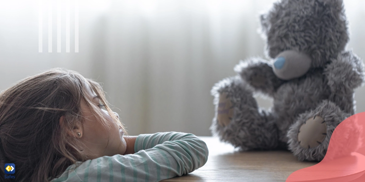 This girl has stopped playing with her teddy bear, a toy she enjoyed playing with before, due to stress.