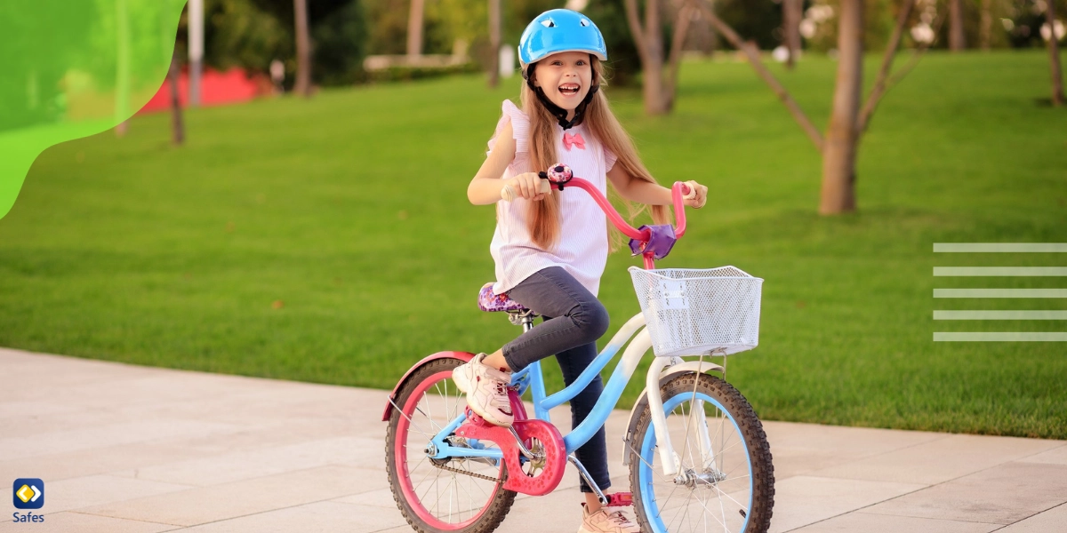 cheerful child girl cycling in the park