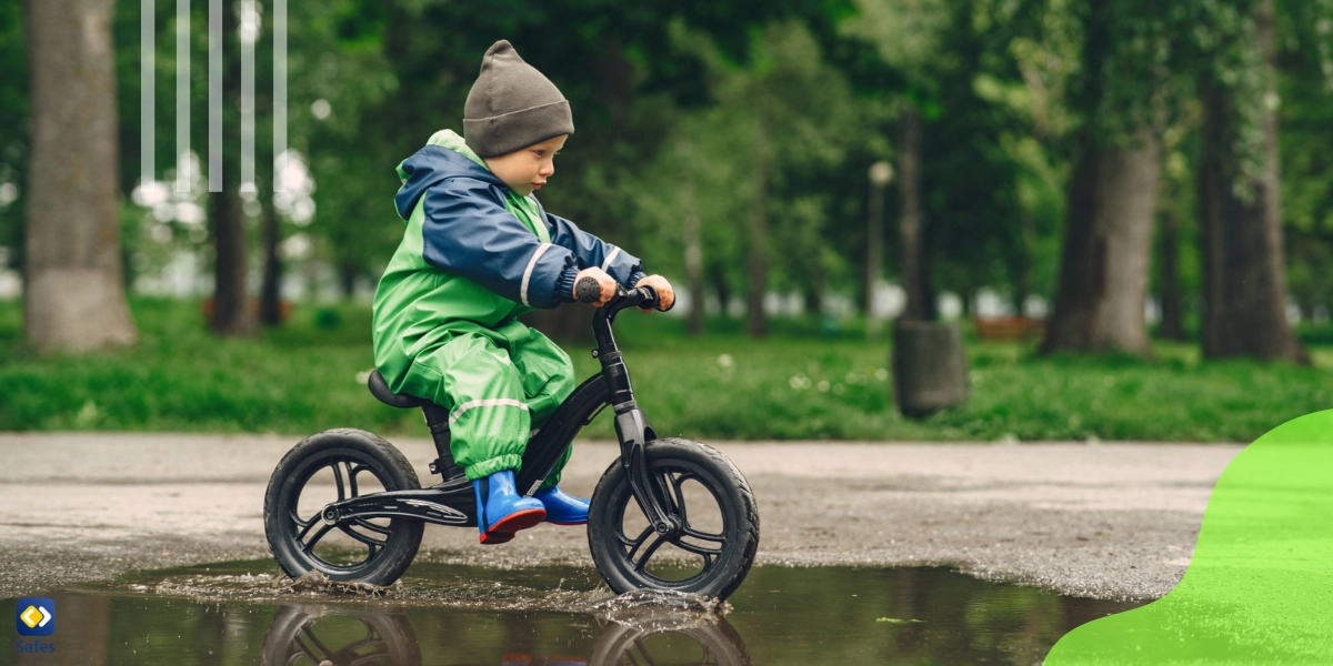 kid in rain boots playing in a rain park