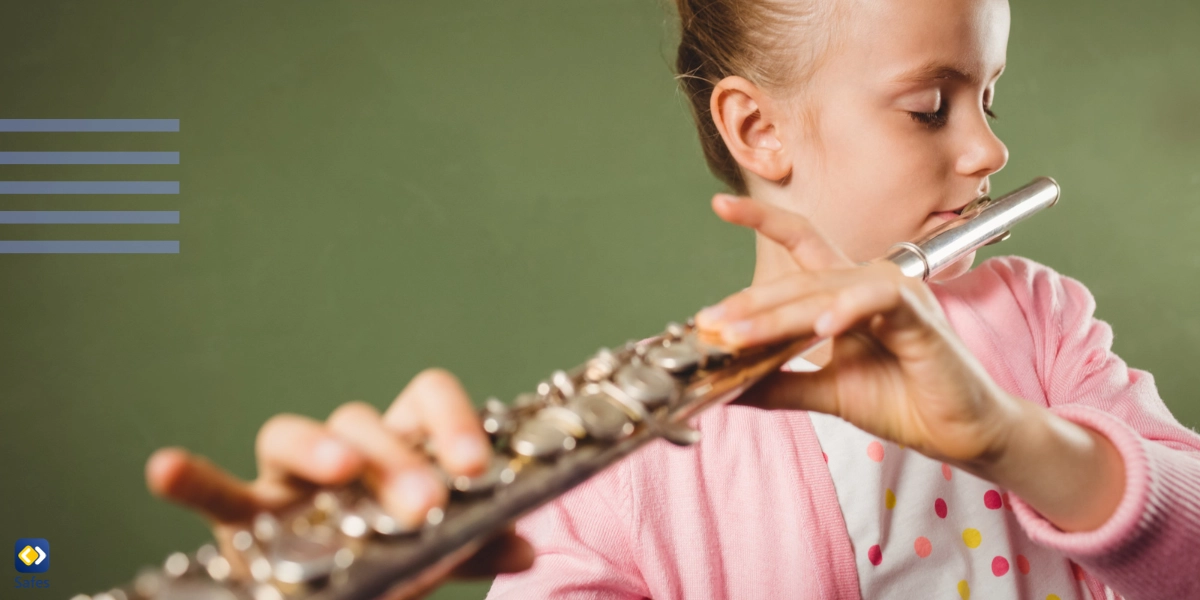 Little girl using a wind instrument