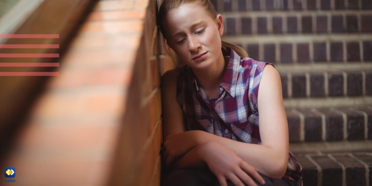 Teenager with depression in school hallway