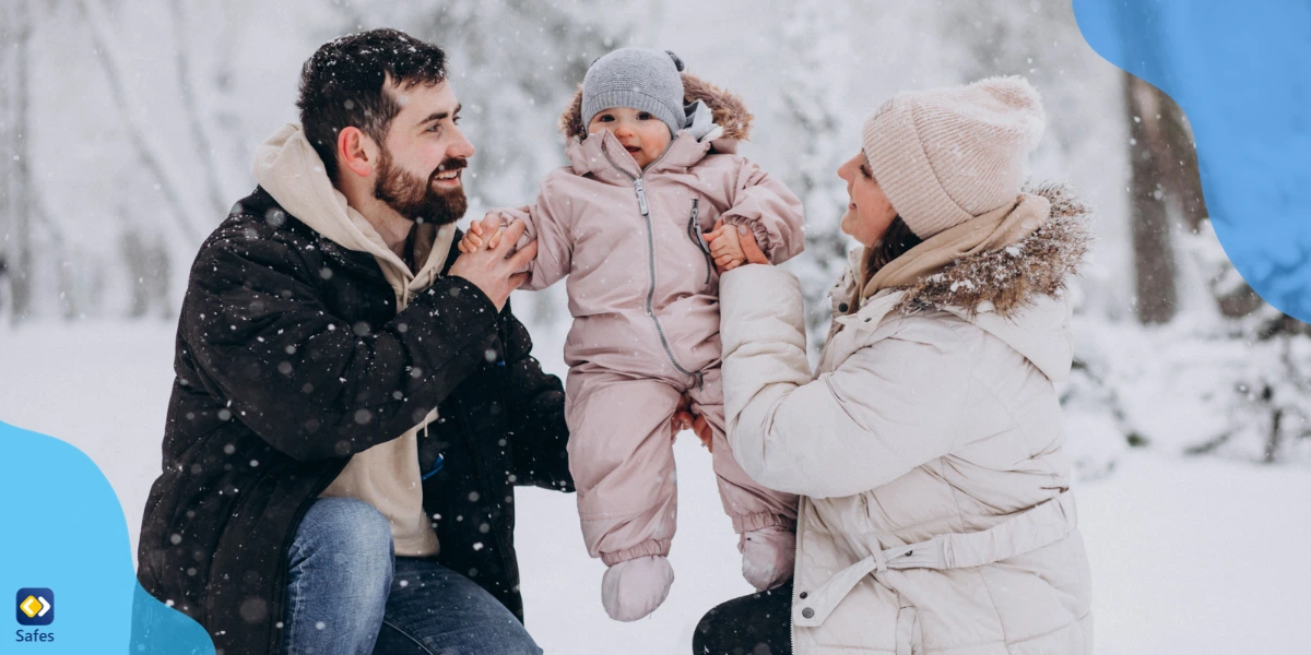 A family of three having fun in the snow.
