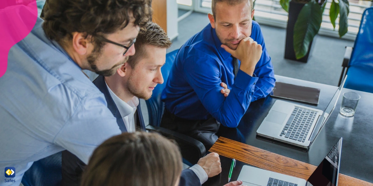 Four executives, working in a tech company, discussing ways to reduce the negative side effects of their products.