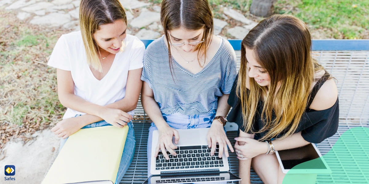 Three teen girls using educational websites to study lessons