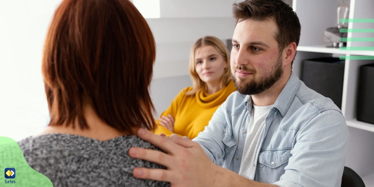 A father comforting her teenage daughter, a victim of cyberbullying, in front of her mother.