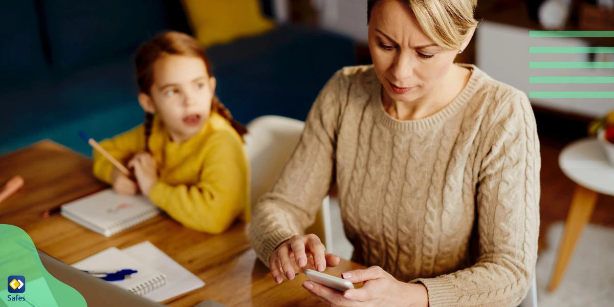 A mother using her phone instead of paying attention to her kid