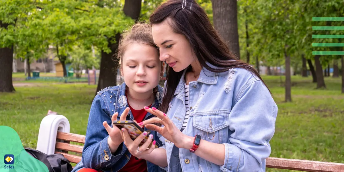 a mother spending time with her daughter outdoors while playing with her phone, establishing a healthy digital diet for her
