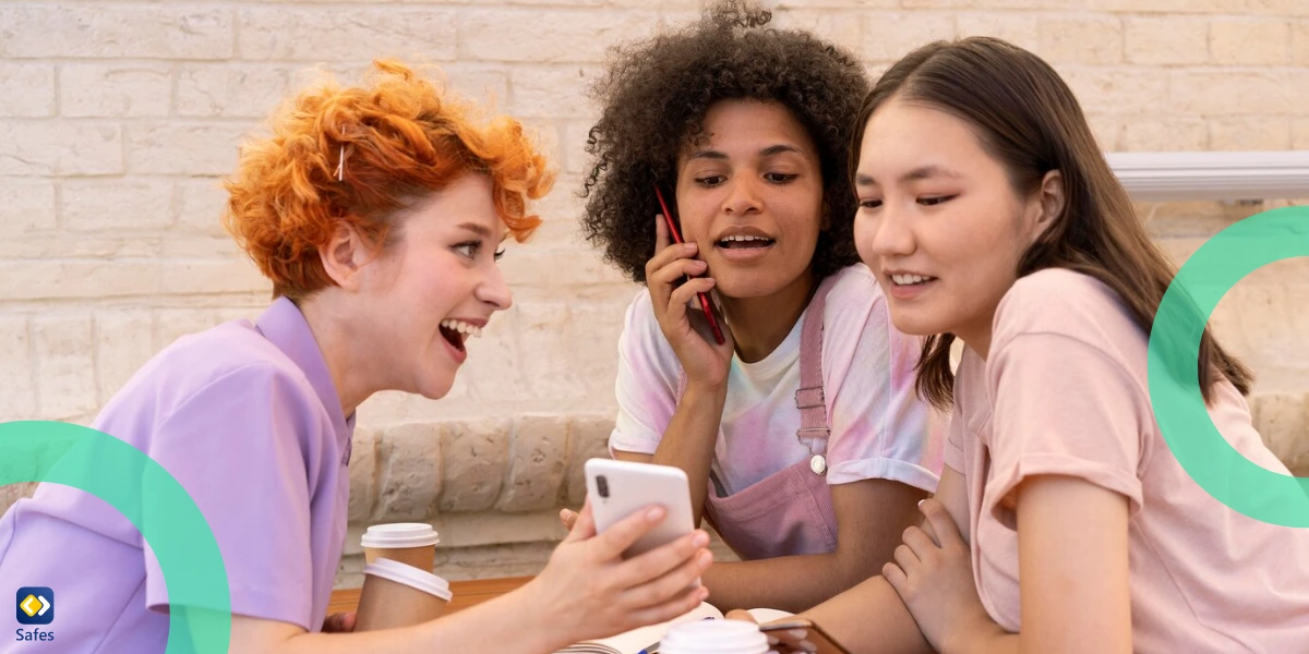 Happy teens showing each other something on their phone