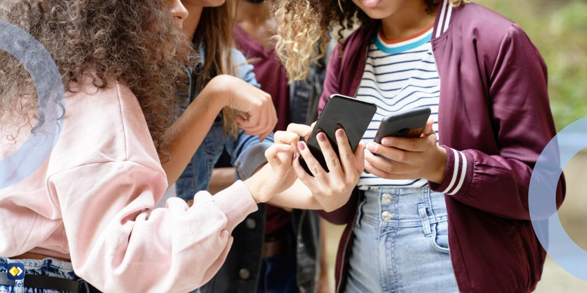 group of teens staring at their phones