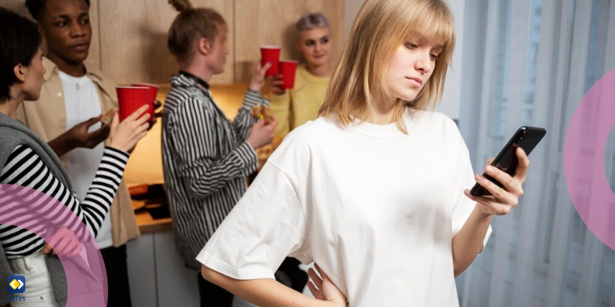 A teen girl is standing alone and is upset because of a mean comment on social media.
