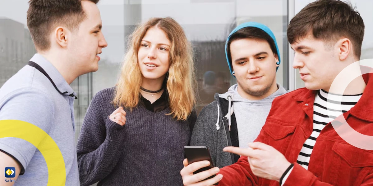 Friends using smartphones outdoors and talking to each other