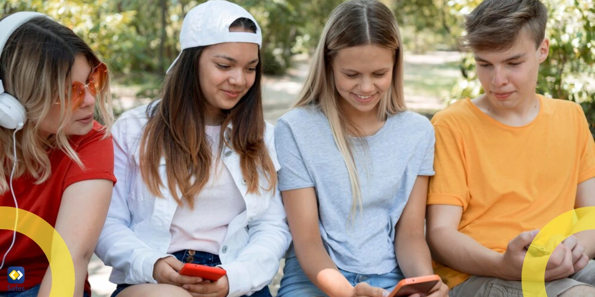 a group of teen friends holding their phones and chatting together