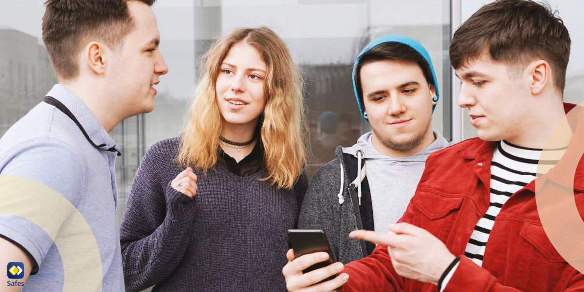 a group of friends using smartphones outdoors