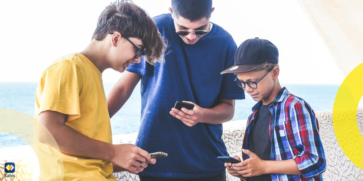Smiling boys using smart phones