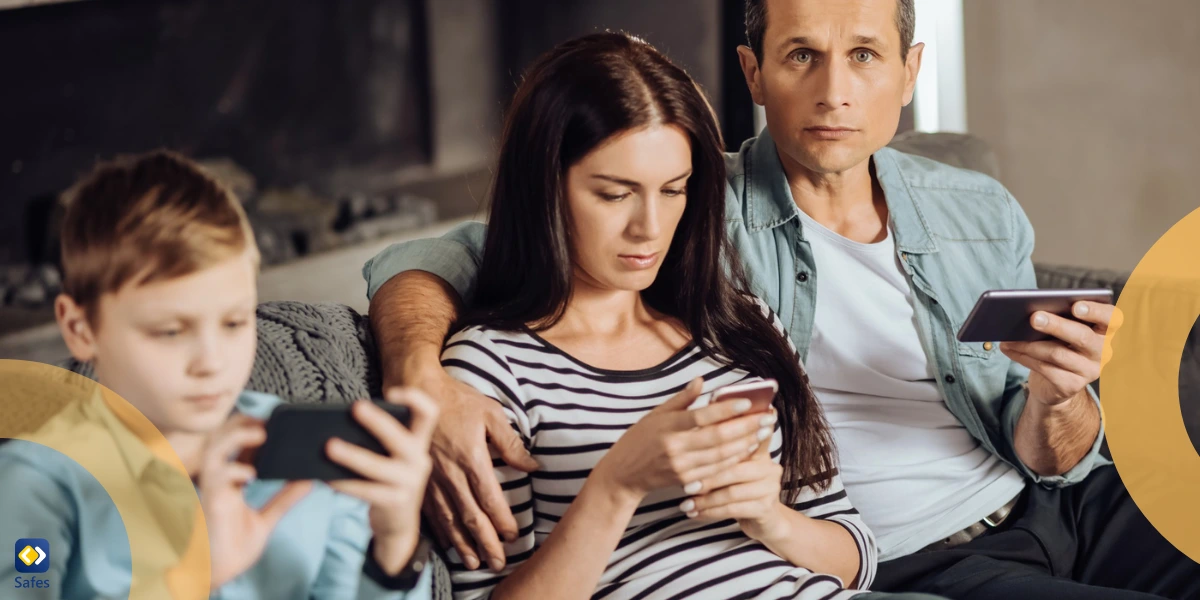 parents and their child sitting on the couch using their phones