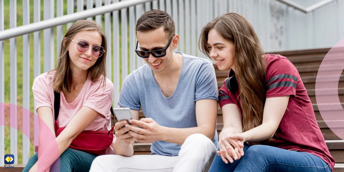 friends are looking on mobile and smiling