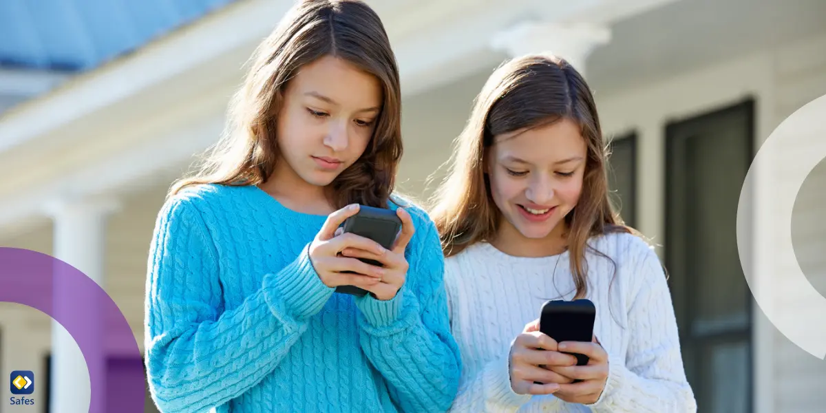 teen twin sisters using their smartphones