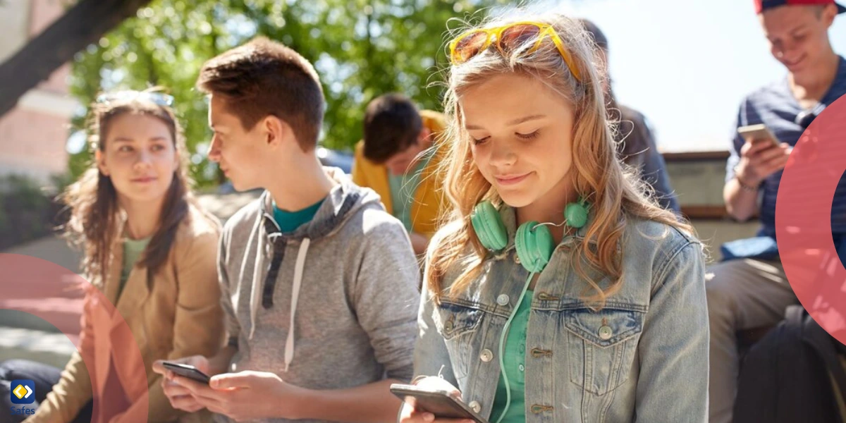a group of happy teenage friends using their smartphones