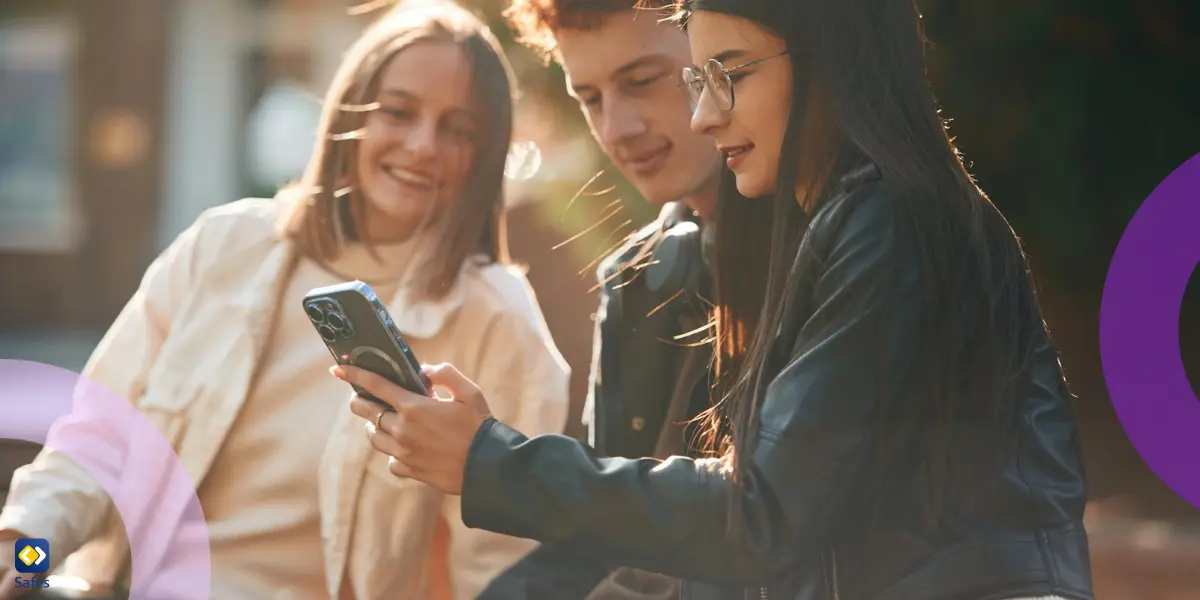 Girl is showing something on smartphone to friends